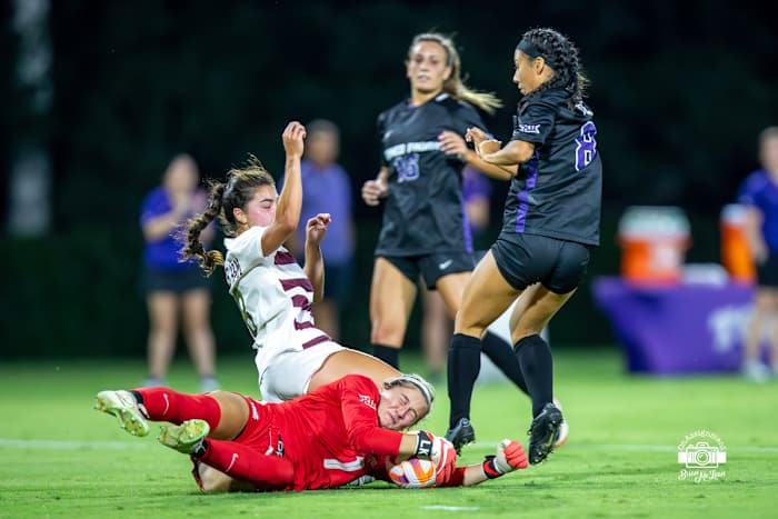 Lauren Kellett (1) makes a diving save in traffic.